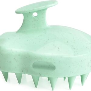 Light green scalp massage shampoo brush made of eco-friendly material, featuring a unique speckled design with sturdy silicone bristles and an ergonomic top handle for easy use