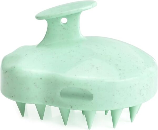 Light green scalp massage shampoo brush made of eco-friendly material, featuring a unique speckled design with sturdy silicone bristles and an ergonomic top handle for easy use