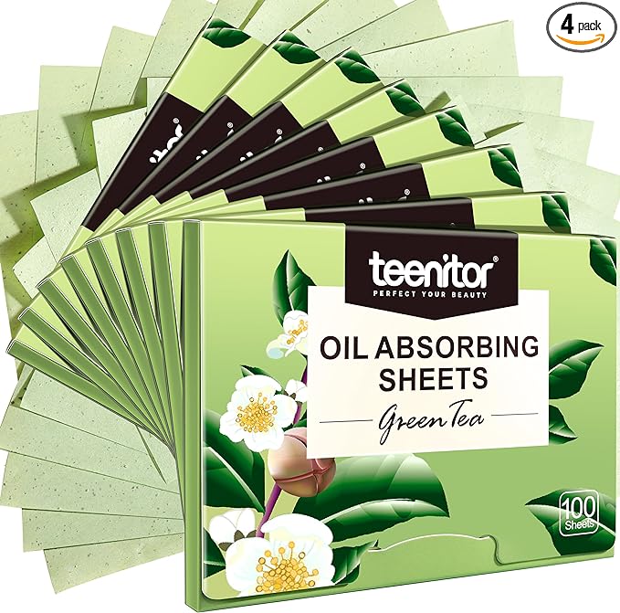 Multiple packages of Teentor Green Tea Oil Absorbing Sheets fanned out. Each package is green with floral graphics and contains 100 sheets