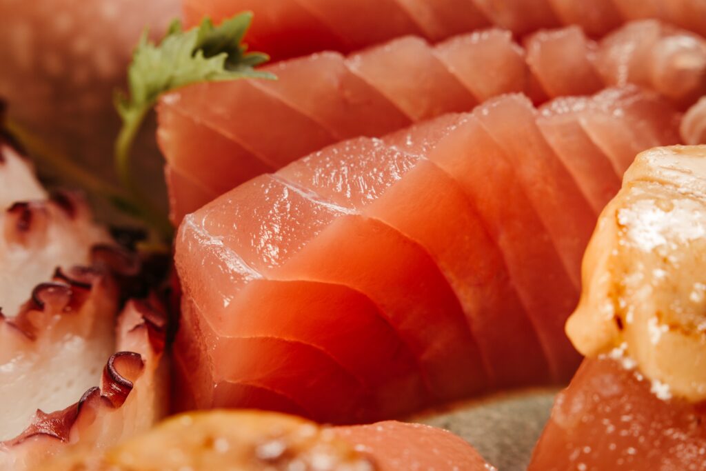 pexels-photo-28559517-28559517 Appetizing close-up image showcasing a variety of fresh sushi and sashimi with vibrant colors and textures.