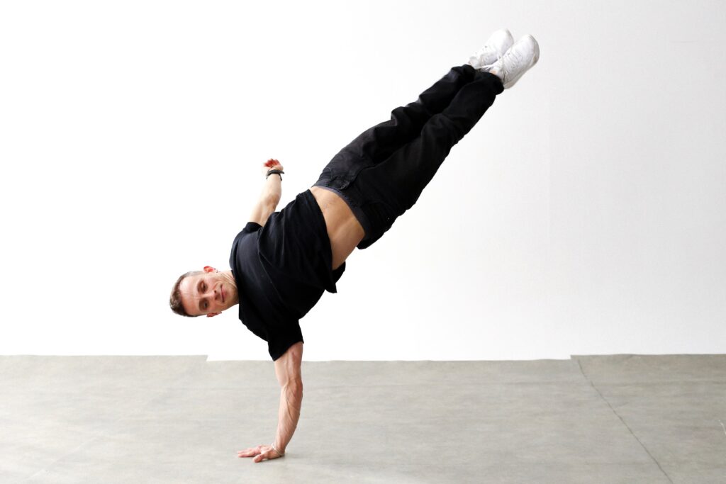 pexels-photo-30662205-30662205 Breakdancer in mid-air handstand showcasing acrobatics in Berlin studio.