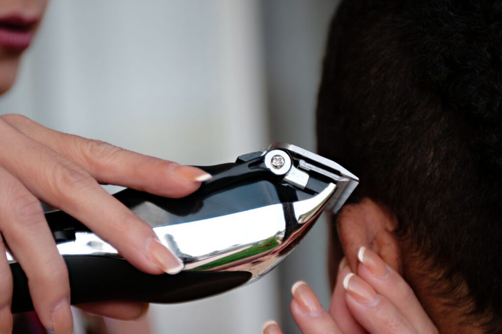 pexels-photo-36043163-36043163 A detailed view of a hair clipper being used to cut hair. Ideal for grooming and barbering concepts.