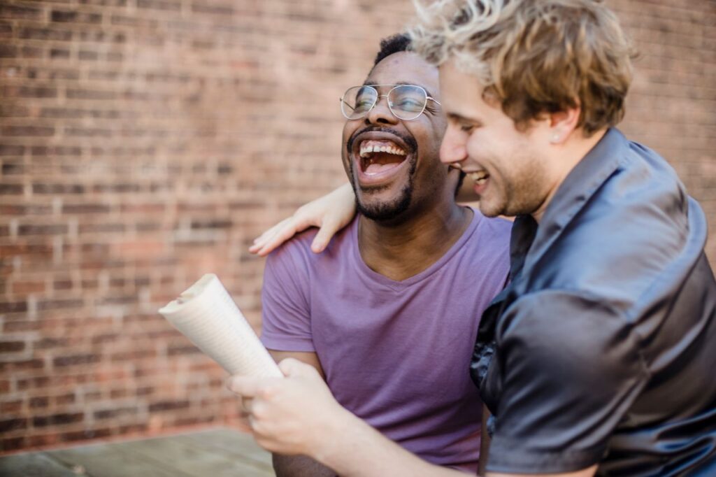 pexels-photo-4658206-4658206 Two happy men in a loving, joyful moment, sharing laughter on a sunny day.